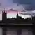 The sun sets behind the Houses of Parliament