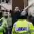 British police officers control anti-Muslim demonstraors gesturing and chanting towards Muslim protesters in the London suburb of Harrow
