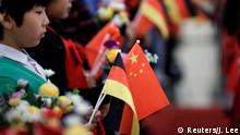 Students hold flags of China and Germany before a welcome ceremony hosted by China's President Xi Jinping for German President Frank-Walter Steinmeier at the Great Hall of the People in Beijing, China December 10, 2018. REUTERS/Jason Lee