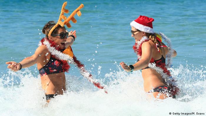 Australian women on a beach in Christmas gear (Getty Images/M. Evans)