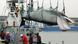 Captured whale above ship Captured whale above ship