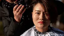 Li Wenzu has her head shaved to protest the detention of her husband and Chinese human rights lawyer Wang Quanzhang, detained during the 709 crackdown, in Beijing on December 17, 2018. - Li and a group of women protested the detention of their husbands who have have been held since 2015 when more than 200 lawyers and activists were detained in a swoop, known as the 709 crackdown, on those who had taken on civil rights cases considered sensitive by China's tightly controlled courts. (Photo by FRED DUFOUR / AFP) (Photo credit should read FRED DUFOUR/AFP/Getty Images)