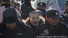 Li Wenzu (C-short hair), wife of human rights lawyer Wang Quanzhang who was on trial in Tianjin following his detention in the 709 crackdown, is forced away by security personnel and police officers as she protests against her husband's detention, outside the Hongsecun People's high court in Beijing on December 28, 2018. - Wang is charged with being influenced by infiltrating anti-China forces, of being trained by a foreign group and accepting their funding, and of having subversive thoughts as a result. (Photo by Nicolas ASFOURI / AFP) (Photo credit should read NICOLAS ASFOURI/AFP/Getty Images)