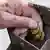 An elderly person takes the last few coins out of a wallet