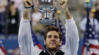 Juan Martin del Potro, of Argentina, holds up the championship trophy after winning the men's finals championship over Roger Federer, of Switzerland, at the U.S. Open tennis tournament in New York, Monday, Sept. 14, 2009.(AP Photo/Charles Krupa)