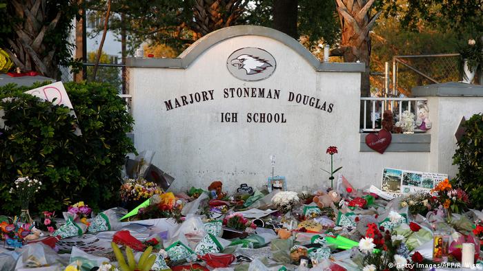 Flowers, candles and mementos sit outside one of the makeshift memorials at Marjory Stoneman Douglas High School in Parkland, Florida