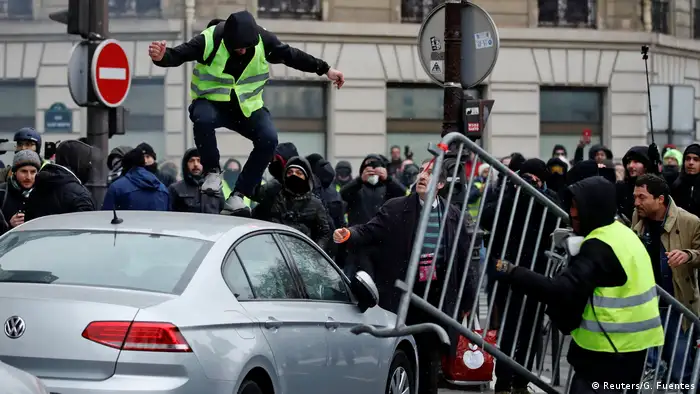 A protester jumps on a car in Paris (Reuters/G. Fuentes)