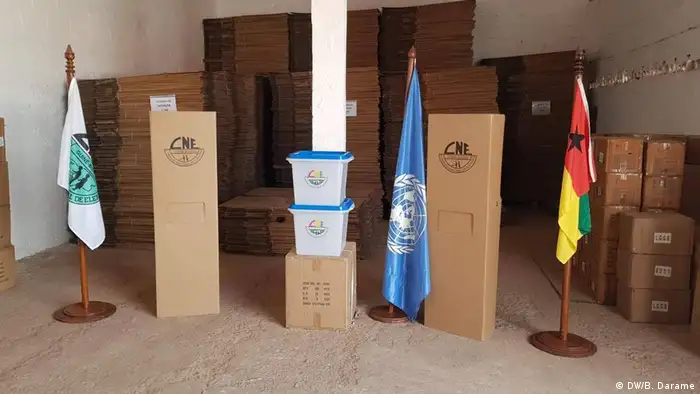 Boxes with election material - next to them, the UN and the national flag