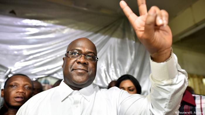 Felix Tshisekedi makes a victory sign with his fingers