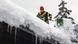 A firefighter shovels snow off a roof in Berchtesgaden A firefighter shovels snow off a roof in Berchtesgaden