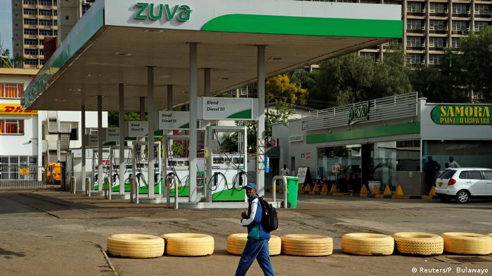 A man walks past a closed petrol station in Harare