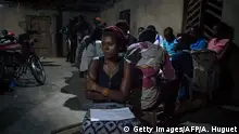 A woman stands in a building requisitioned to serve as a place for the counting of ballot boxes after a symbolic vote on December 30, 2018, at Kalinda Stadium in Beni, where voting was postponed for Democratic Republic of Congo's general elections. - After two years of delays, crackdowns and political turmoil, the Democratic Republic of Congo voted on December 30 in presidential elections that will determine the future of Africa's notoriously unstable giant. Electoral authorities have postponed the vote until March 2019 in several troubled areas such as Beni and Butembo in North Kivu province (eastern RDCongo), and in Yumbi (western RDCongo). (Photo by ALEXIS HUGUET / AFP) (Photo credit should read ALEXIS HUGUET/AFP/Getty Images)