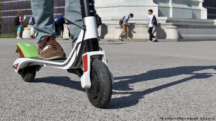Man standing on an e-scooter 