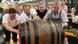 Four men push a giant keg of beer at the Oktoberfest Four men push a giant keg of beer at the Oktoberfest