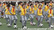 Young Chinese students perform a football exercise at Duqiao Primary School in Linhai city, east China's Zhejiang province, 26 March 2015.
China is to overhaul its soccer authorities in an effort to qualify for the World Cup within a decade and be seen as a potential host for the competition. At the heart of the plan is separating the Chinese Football Association (CFA) from the government sports regulator, the General Administration for Sport. The CFA will become a fully independent, non-profit organization overseeing the development of soccer and will have the power to reject unreasonable government interventions, according to a central government directive. The central government also plans to step up financial support for the national team and the sport in general. Its key initiatives include establishing a national lottery based on Chinese soccer leagues, with revenue going towards development of the sport, and building 50,000 soccer schools by 2025. The directive follows a high-level meeting on February 27 chaired by President Xi Jinping with the aim of revamping Chinese soccer. Xi has three goals: qualifying, hosting and winning the World Cup. Many fans are embarrassed by the national team, with the country's increasing geopolitical influence not matched by its lowly world soccer ranking. Fifa ranks China at No 83, between Guatemala and Angola. |
