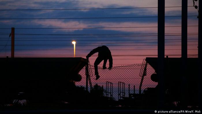 Silhouette of a migrant near the Eurotunnel in Calais
