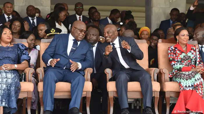 Joseph Kabila sits next to Felix Tshisekedi during the inauguration in Kinshasa