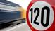 A truck passes a 120 km/h (75 mph) speed limit sign A truck passes a 120 km/h (75 mph) speed limit sign