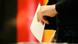 A woman casts her ballot for the German general elections in Berlin A woman casts her ballot for the German general elections in Berlin