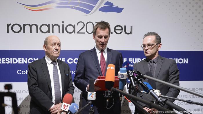 German Foreign Minister Heiko Maas, right, French Foreign Minister Jean-Yves Le Drian, left, and Jeremy Hunt United Kingdom's Secretary of State for Foreign and Commonwealth Affairs in front of a microphone