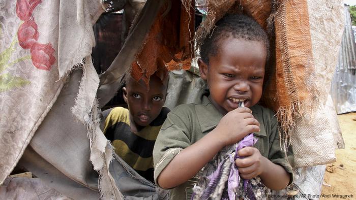 Two Somali boys inside a makeshift shelter