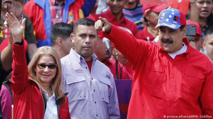 Nicolas Maduro and his wife wave to supporters at a rally