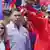 Nicolas Maduro and his wife wave to supporters at a rally