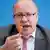 Peter Altmaier waves a highlighter in the air