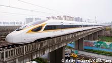 NANJING, CHINA - JULY 01: No. G118 Fuxing bullet train runs out of Nanjing South Railway Station on July 1, 2018 in Nanjing, Jiangsu Province of China. New longer Fuxing bullet trains start operation on July 1 in China. The new train is more than 400 meters long and has 16 carriages, twice as many as old ones. (Photo by Su Yang/VCG/Getty Images)