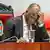 President John Magufuli leans his head on his hands