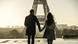A couple walks in front of the Eiffel Tower A couple walks in front of the Eiffel Tower