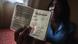 A South African woman holds up her passport to the camera A South African woman holds up her passport to the camera