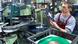 A worker inspecting a vinyl record A worker inspecting a vinyl record