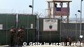 GUANTANAMO BAY, CUBA - APRIL 7: U.S. Army soldiers stand at the entrance to Camp Delta where detainees from the U.S. war in Afghanistan live April 7, 2004 in Guantanamo Bay, Cuba. On April 20, the U.S. Supreme Court is expected to consider whether the detainees can ask U.S. courts to review their cases. Approximately 600 prisoners from the U.S. war in Afghanistan remain in detention. (Photo by Joe Raedle/Getty Images)
