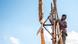 Film still from The Boy Who Harnessed the Wind - a boy on a wooden construction Film still from The Boy Who Harnessed the Wind - a boy on a wooden construction