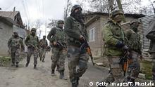 Indian soldiers take part in a search operation after a gunbattle between suspected militants and government forces in the Balhama area of Khanmoh district near Srinagar on March 16, 2018.
Two Kashmiri militants were killed and one residential house was gutted where they had hold up during an encounter with Indian security forces on March 16, after militants attacked the personal security guard of a BJP leader. / AFP PHOTO / Tauseef MUSTAFA (Photo credit should read TAUSEEF MUSTAFA/AFP/Getty Images)