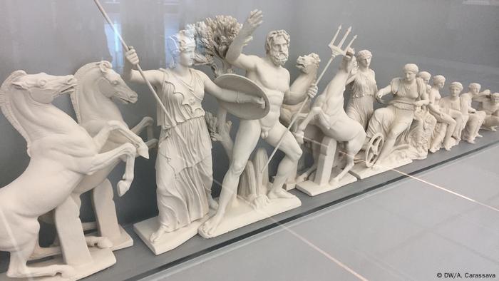 Figures of Greek gods and goddesses in battle and horses.