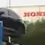 A car transporter leaves the Honda car plant in Swindon