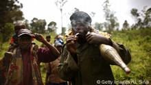RUSEKERA, DR CONGO - NOVEMBER 05: (ISRAEL OUT) A member of the National Congress for the Defense of the People (CNDP) lights a cigarette in the bush on November 5, 2008 near the village of Rusekera, Democratic Republic of Congo. According to reports rebel leader Laurent Nkunda claims that a week-old cease-fire is still in place despite recent clashes between Congolese Tutsi rebels and pro-government militia. (Photo by Uriel Sinai/Getty Images)