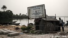 An order signboard by Hydrocarbon Pollution Restoration Project (HYPREP) is seen with the message can read Polluted water - Do not drink, or swim here at the River Bodo, which was damaged by the devastating oil spills from the pipeline about 10 years ago in Bodo village of Ogoniland, which is part of the Niger Delta region, Nigeria, on Feburuary 19, 2019. - Two oil spills caused by corroded pipelines of Anglo-Dutch oil giant Shell between 2008 and 2009 destroyed the ecosystem of the creeks in the Niger Delta. Shell has paid compensation to the communities and promised clean-up operation but oil remains along the river bank. (Photo by Yasuyoshi CHIBA / AFP)