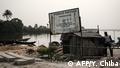 An order signboard by Hydrocarbon Pollution Restoration Project (HYPREP) is seen with the message can read Polluted water - Do not drink, or swim here at the River Bodo, which was damaged by the devastating oil spills from the pipeline about 10 years ago in Bodo village of Ogoniland, which is part of the Niger Delta region, Nigeria, on Feburuary 19, 2019. - Two oil spills caused by corroded pipelines of Anglo-Dutch oil giant Shell between 2008 and 2009 destroyed the ecosystem of the creeks in the Niger Delta. Shell has paid compensation to the communities and promised clean-up operation but oil remains along the river bank. (Photo by Yasuyoshi CHIBA / AFP)