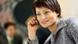 A young woman talks on a mobile phone. A young woman talks on a mobile phone.