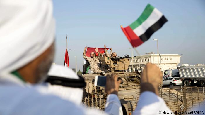 A handout picture made available by the Emirates News Agency (WAM) shows citizens greeting a convoy of UAE military vehicles and personnel as it travels from Al Hamra Military Base to Zayed Military City, marking the return of the first batch of UAE Armed Forces military personnel from Yemen, at Marfa, western region of Abu Dhabi, UAE, 07 November 2015