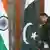 An Indian official adjusts the Pakistani flag prior to delegation levels talks at the Hyderabad House in New Delhi, India on 25 February 2010.