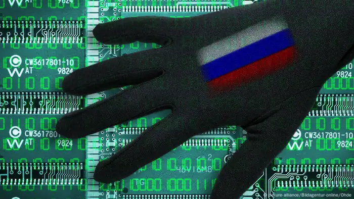 Black hand with a Russian flag on it over computer code