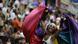 A woman wearing a rainbow cape celebrates the opening of Carnival in Rio de Janeiro, Brazil A woman wearing a rainbow cape celebrates the opening of Carnival in Rio de Janeiro, Brazil