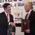 Australian Trade Minister Simon Birmingham and Indonesian Trade Minister Enggartiasto Lukita shake hands after signing a free trade agreement