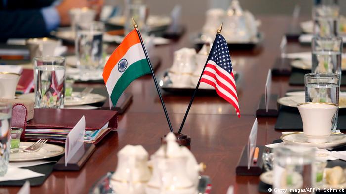 The flags of the United States and India adorn a conference table during a meeting between US and Indian officials