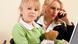 A woman speaks on the phone in a business suit while sitting with a young girl who is holding a teddy bear (Colourbox) A woman speaks on the phone in a business suit while sitting with a young girl who is holding a teddy bear (Colourbox)