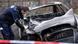 Investigators examines a torched vehicle Investigators examines a torched vehicle